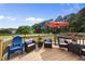 Inviting deck with comfortable seating, complete with an umbrella and scenic backyard view at 6 W Canterbury Ct, Wendell, NC 27591