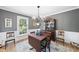 Traditional dining room featuring a wooden table, china cabinet, and window with outdoor views at 6 W Canterbury Ct, Wendell, NC 27591