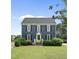 Charming two-story home with a manicured lawn, black shutters, and a bright green front door at 6 W Canterbury Ct, Wendell, NC 27591