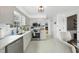 Well-lit kitchen with white cabinetry, stainless steel appliances, and a view to the living room at 6 W Canterbury Ct, Wendell, NC 27591