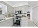 Corner kitchen with stainless steel range, white quartz countertops, and grey cabinets at 6 W Canterbury Ct, Wendell, NC 27591