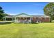 Beautiful brick home with a covered back porch and lush green lawn, perfect for outdoor enjoyment at 6080 Us 421 N, Lillington, NC 27546