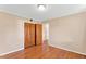 This bedroom features a wood floor, neutral walls, and a closet with wood doors at 6080 Us 421 N, Lillington, NC 27546
