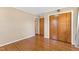 This bedroom features a wood floor, neutral walls, and a closet with wood doors at 6080 Us 421 N, Lillington, NC 27546
