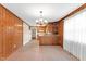 Dining room featuring wood paneled walls and a view to kitchen and living areas at 6080 Us 421 N, Lillington, NC 27546