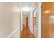 This hallway features a wood floor, neutral walls, and leads to a kitchen at 6080 Us 421 N, Lillington, NC 27546