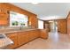 Inviting kitchen with wood cabinets and granite countertops and view to dining area at 6080 Us 421 N, Lillington, NC 27546