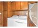 The laundry room has a washer and dryer with storage above at 6080 Us 421 N, Lillington, NC 27546