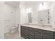 Bathroom featuring double sinks, gray cabinets, and modern fixtures for a sleek look at 615 Daniels St # 215, Raleigh, NC 27605