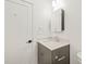 Modern bathroom features a sleek gray vanity, stylish mirror and hardware at 615 Daniels St # 215, Raleigh, NC 27605