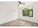Sunlit bedroom with a ceiling fan and a large window with lush, green views at 615 Daniels St # 215, Raleigh, NC 27605