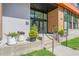 Inviting building entrance with decorative planters and a modern glass door at 615 Daniels St # 215, Raleigh, NC 27605