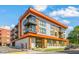 Modern condo building with balconies and a colorful exterior design on a sunny day at 615 Daniels St # 215, Raleigh, NC 27605