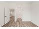 Hallway leading to the kitchen, bathroom, and other rooms, with light wood flooring at 615 Daniels St # 215, Raleigh, NC 27605
