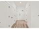 Bright hallway with wood-look flooring and white doors, leading to various rooms at 615 Daniels St # 215, Raleigh, NC 27605