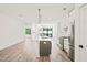 Open-concept kitchen with a large island, stainless steel appliances, and modern lighting at 615 Daniels St # 215, Raleigh, NC 27605