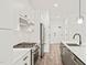 Close-up of a kitchen featuring stainless steel appliances and a stylish kitchen island at 615 Daniels St # 215, Raleigh, NC 27605