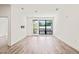 Spacious living room with hardwood floors, large windows, and ample natural light at 615 Daniels St # 215, Raleigh, NC 27605