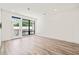 Bright living room featuring wood floors, a balcony door, and natural light at 615 Daniels St # 215, Raleigh, NC 27605
