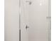 Close up of a shower with white subway tile and glass doors at 615 Daniels St # 215, Raleigh, NC 27605