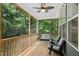 Relaxing screened porch with ceiling fan, bench, and seating area overlooking a lush backyard at 619 E Hatterleigh Ave, Hillsborough, NC 27278