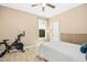Bright bedroom with hardwood floors and a Peloton bike at 619 E Hatterleigh Ave, Hillsborough, NC 27278