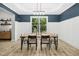 Elegant dining room with modern table and chairs under a stylish light fixture at 619 E Hatterleigh Ave, Hillsborough, NC 27278