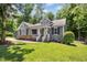 Inviting single-story home with a charming front porch, perfect landscaping, and lush green lawn at 619 E Hatterleigh Ave, Hillsborough, NC 27278