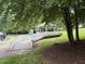 A quaint gazebo on a lush green lawn with accessible wooden boardwalk and nearby playground at 619 E Hatterleigh Ave, Hillsborough, NC 27278
