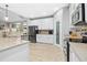 Spacious kitchen featuring white cabinets, stainless steel appliances, and a pantry at 619 E Hatterleigh Ave, Hillsborough, NC 27278