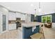 Well-lit kitchen with white cabinets, granite countertops, and stylish pendant lighting at 619 E Hatterleigh Ave, Hillsborough, NC 27278