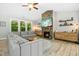 A spacious living room showcases a stone fireplace, cozy seating, and abundant natural light at 619 E Hatterleigh Ave, Hillsborough, NC 27278