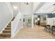 Open-concept home with a staircase, wood-look floors, and a spacious living area at 619 E Hatterleigh Ave, Hillsborough, NC 27278