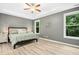 Calm main bedroom featuring windows that provide great natural light and a ceiling fan at 619 E Hatterleigh Ave, Hillsborough, NC 27278