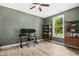 Home office with a ceiling fan, natural light, and wood-look LVP floors at 619 E Hatterleigh Ave, Hillsborough, NC 27278