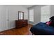 Bedroom with bed, dresser, window and dark wood floors at 624 Powhatan Dr, Fuquay Varina, NC 27526