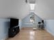 Light filled bedroom featuring a desk, skylight and window views at 624 Powhatan Dr, Fuquay Varina, NC 27526