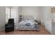 A comfortable bedroom with neutral walls and light wood-look tile flooring at 624 Powhatan Dr, Fuquay Varina, NC 27526