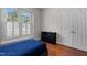Bedroom with a bed, a window, a closet, and dark wood floors at 624 Powhatan Dr, Fuquay Varina, NC 27526