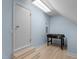Bonus room with light blue walls, wood flooring, and a foosball table at 624 Powhatan Dr, Fuquay Varina, NC 27526