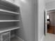 Walk-in closet with white shelving and view into another room at 624 Powhatan Dr, Fuquay Varina, NC 27526