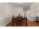 Well-lit dining room featuring hardwood floors and a view of the living room at 624 Powhatan Dr, Fuquay Varina, NC 27526