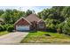 Brick home on a well-manicured lawn, with a paved driveway and welcoming entrance at 624 Powhatan Dr, Fuquay Varina, NC 27526