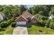 Charming brick home features a two-car garage and a well-maintained front lawn at 624 Powhatan Dr, Fuquay Varina, NC 27526