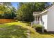 Charming home's front yard featuring a well-maintained lawn, fence, and lush greenery at 624 Powhatan Dr, Fuquay Varina, NC 27526