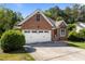 Attached garage and landscaped front yard create a welcoming feel at 624 Powhatan Dr, Fuquay Varina, NC 27526