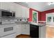 Well-equipped kitchen with granite countertops, stainless appliances, and white cabinets at 624 Powhatan Dr, Fuquay Varina, NC 27526