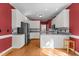 Bright kitchen featuring white cabinets, stainless steel appliances and granite counters at 624 Powhatan Dr, Fuquay Varina, NC 27526