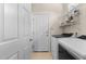 Well-lit laundry room with washer, dryer, shelving, and access to outside at 624 Powhatan Dr, Fuquay Varina, NC 27526