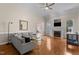 Bright living room featuring a fireplace, hardwood floors, and neutral color scheme at 624 Powhatan Dr, Fuquay Varina, NC 27526